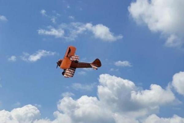 A biplane flying in the sky