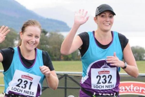 Jennifer and Lynsey running and waving during the Loch Ness marathon