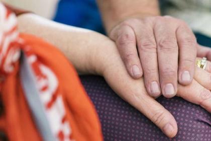 A closeup of a couple holding hands