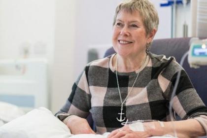 A woman in a checkered jumper having chemotherapy