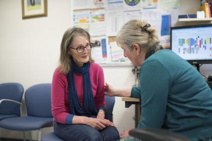 A woman is comforted by a GP in the GP's office