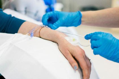 Close up of a nurse inserting a drip for chemotherapy
