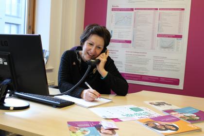 Target Ovarian Cancer Nurse Adviser, Val Lang, smiling while taking a call on our support line