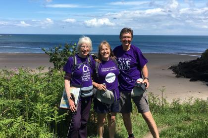 Three Target Ovarian Fundriasers walking along a sunny coastal path