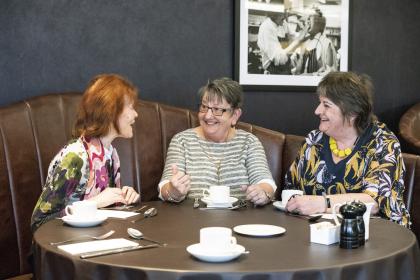 Three women talking to and supporting each other