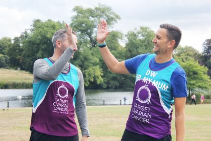 Two Target Ovarian Cancer athletic fundraisers hi five each other - Rob and Darren - Run for Mum
