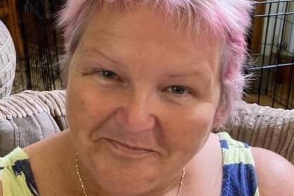 Janet with pink and grey spiky hair smiling