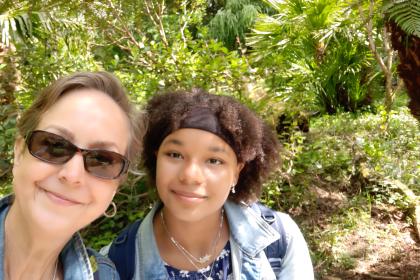 Sarah outside wearing sunglasses with her daughter