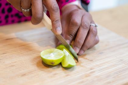 Woman cutting a lime