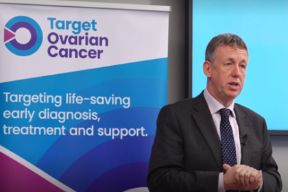 Professor Richard Edmondson speaking at an event in front of a Target Ovarian Cancer banner