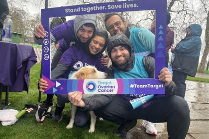 An image of four friends smiling with their dog inside a Target Ovarian Cancer branded frame