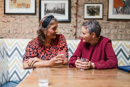 Two women talking at a table