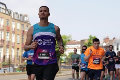 A male supporter running at the Hackney Half Marathon 2024