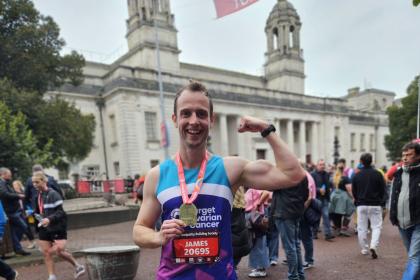 A male supporter smiling at the Cardiff Half Marathon 2024