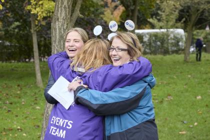 A photo of Annwen in an embrace with fellow Target Ovarian Cancer staff members