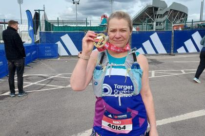 A female supporter smiling at Manchester Marathon 2024