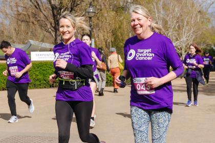 Two female supporters running at Run 11, 2024