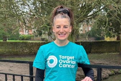 Lisa standing outside wearing a teal coloured Target Ovarian Cancer tshirt