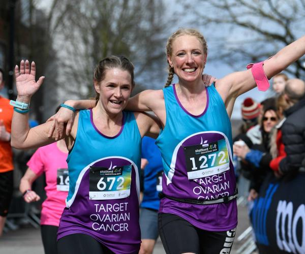 Two Target Ovarian Cancer fundraisers running and waving