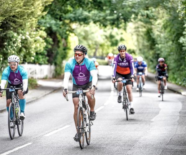 Adam Tuckwell - A Target Ovarian Cancer fundraiser on his bike with team mate at the Ride London event in June 2023 