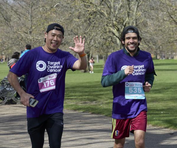 Two male supporters running at Run 11, 2024