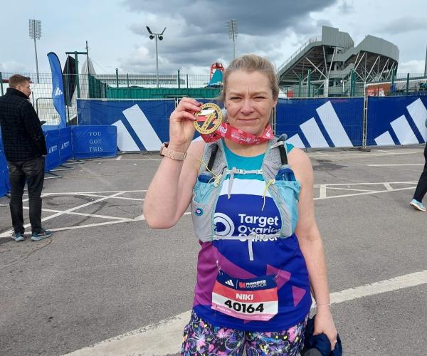 A female supporter smiling at Manchester Marathon 2024