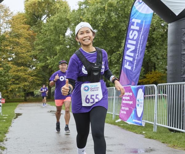 A female supporter running and smiling at Ovar-Dressed London 2024