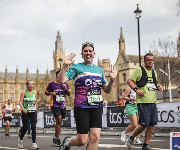A female supporter running and smiling, 2025