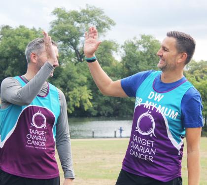 Two Target Ovarian Cancer athletic fundraisers hi five each other - Rob and Darren - Run for Mum
