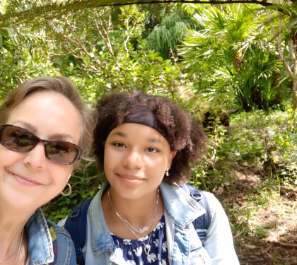 Sarah outside wearing sunglasses with her daughter