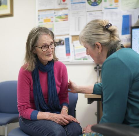 A woman is comforted by a GP in the GP's office