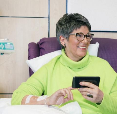 Woman on a phone having chemo