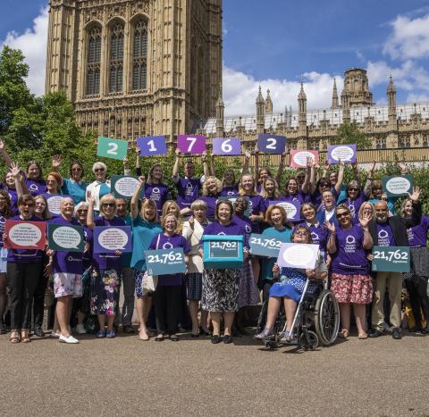 A group of Target Ovarian Cancer campaigners standing outside the House of Lords, Westminster