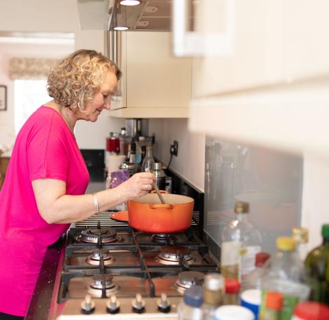 Woman in kitchen cooking