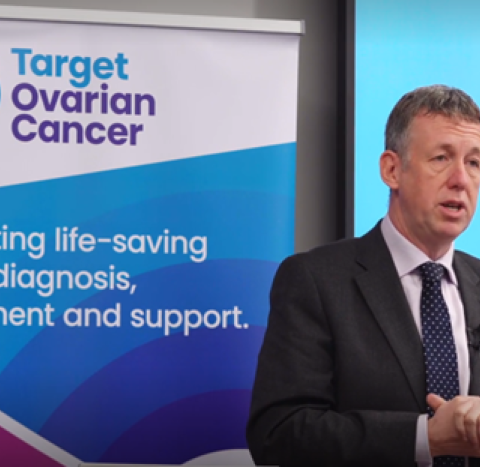 Professor Richard Edmondson speaking at an event in front of a Target Ovarian Cancer banner