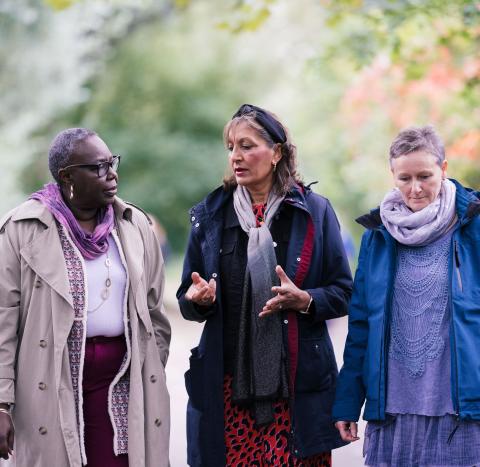 Three women walking in the park talking