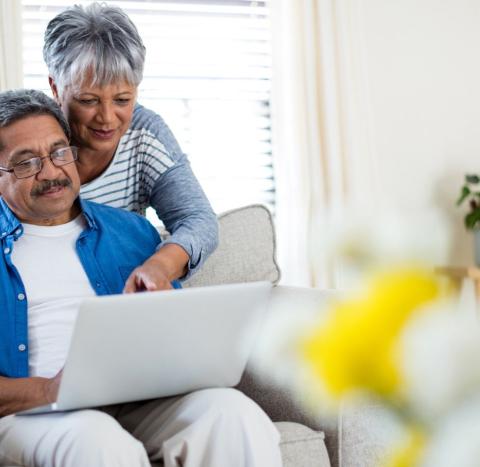 A couple looking at a laptop
