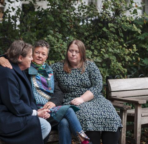 Group of women on a bench talking
