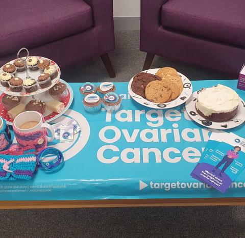 A photo of cakes, tea and Target Ovarian Cancer branded materials displayed on a table