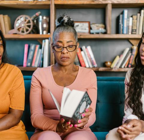 Women together reading book