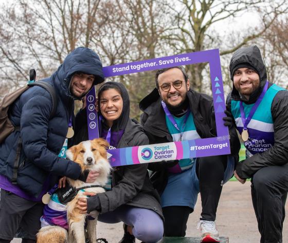 Four people and their dog standing inside a Target Ovarian Cancer smiling