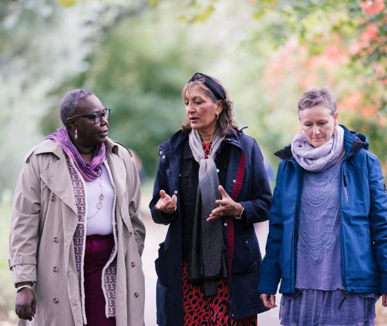 Three women walking in the park talking