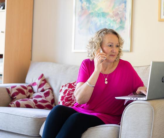Woman on phone and laptop