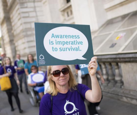 Campaigner holding placard 