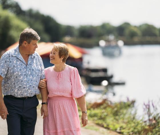 Couple linking arms and walking