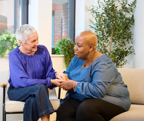 Two women sitting together comforting each other