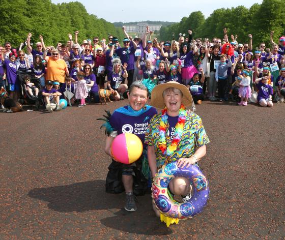 A group of Target Ovarian Cancer fundraisers all in fancy dress standing outside Stormont in Belfast ready to take on our Walk Run
