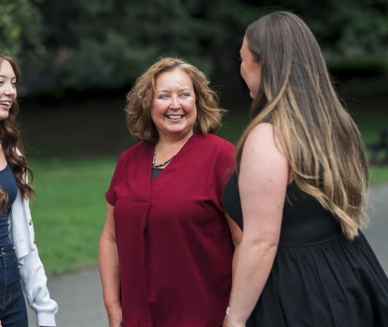 Woman and her daughters standing talking