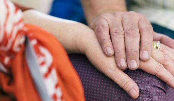 A closeup of a couple holding hands