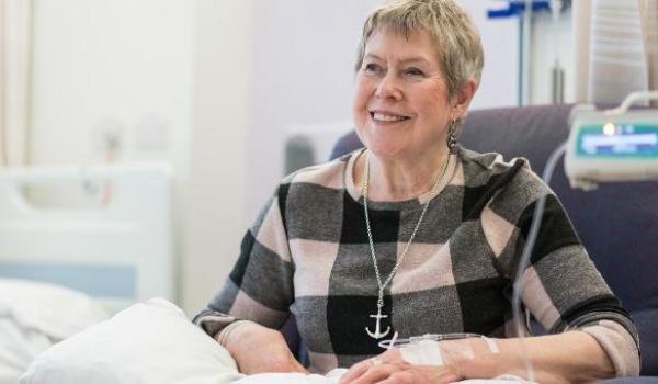 A woman in a checkered jumper having chemotherapy
